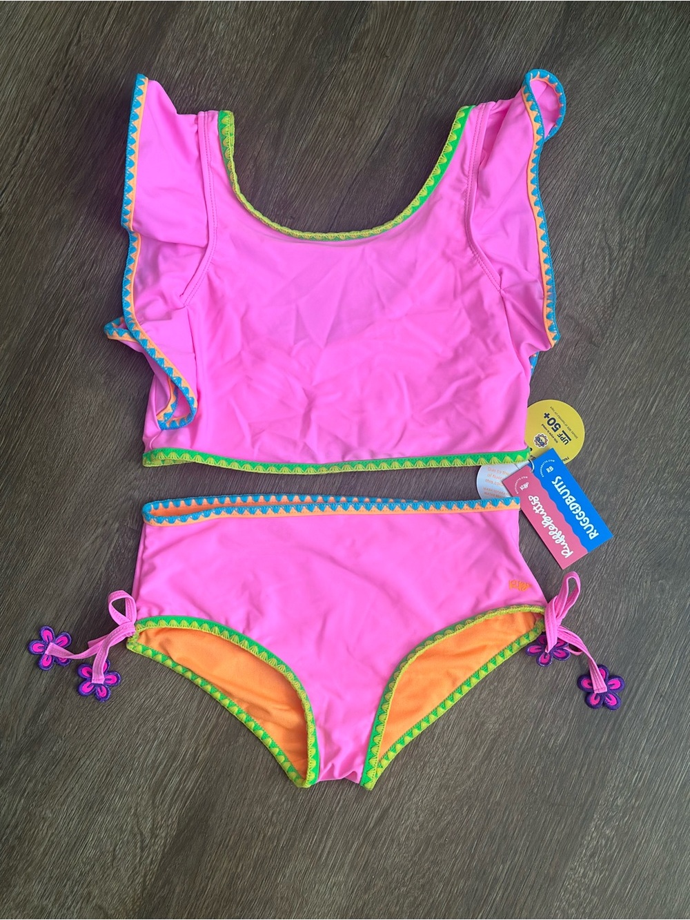 NWT- RuffleButts Girls Two-Piece Swim Set with Orange Lining.